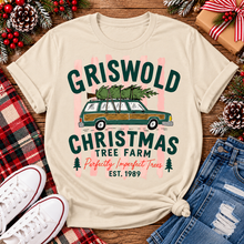 Load image into Gallery viewer, Christmas graphic tee featuring Griswold Christmas Tree Farm vintage green station wagon with Christmas tree and retro lettering.