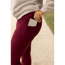 Load image into Gallery viewer, High-waisted maroon bootcut leggings with pockets by Julia Rose, Julia Rose women’s maroon flared leggings lifestyle image