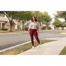 Load image into Gallery viewer, High-waisted maroon crossover leggings with pockets by Julia Rose, Julia Rose women’s maroon full length leggings lifestyle image