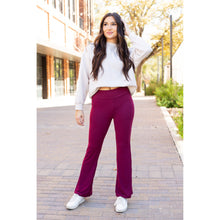 Load image into Gallery viewer, High-waisted maroon bootcut leggings with pockets by Julia Rose, Julia Rose women’s maroon flared leggings lifestyle image