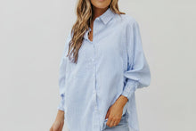Load image into Gallery viewer, This beautiful and versatile blue striped blouse is a must for any boutiques inventory. Pairs will with neutral palettes.