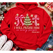 Load image into Gallery viewer, Christian Christmas shirt featuring I Will Praise Him in Every Season Psalm 146:2 graphic with pink bows, decorated Christmas tree, and cream snowflakes.