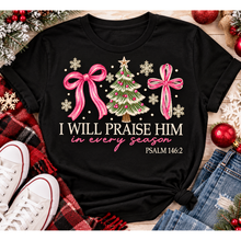 Load image into Gallery viewer, Christian Christmas shirt featuring I Will Praise Him in Every Season Psalm 146:2 graphic with pink bows, decorated Christmas tree, and cream snowflakes.