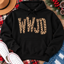 Load image into Gallery viewer, shirt with tan leopard-print WWJD lettering in a rustic holiday flat lay.
