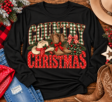 Load image into Gallery viewer, Country Christmas graphic tee with green plaid lettering, red polka dots, cowboy boots, western hat and festive Christmas bows.