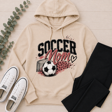 Load image into Gallery viewer, Cream Soccer Mom graphic hoodie featuring pink and black soccer design with leopard print accents.