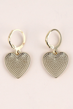 Load image into Gallery viewer, Heart-shaped silver earrings on a light pink background

