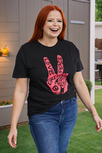 Load image into Gallery viewer, Plus size model wearing graphic black tee with red peace sign
