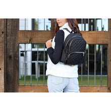 Load image into Gallery viewer, black quilted backpack with gold zipper detail worn by woman stylish everyday backpack
