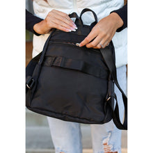 Load image into Gallery viewer, black quilted backpack with gold zipper detail worn by woman stylish everyday backpack
