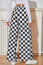 Load image into Gallery viewer, Black and white checkered pants. 
