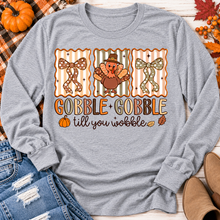 Load image into Gallery viewer, Gobble Gobble Till You Wobble Thanksgiving graphic apparel featuring a cute turkey, polka dot bows, retro fall colors, pumpkins and autumn leaves.
