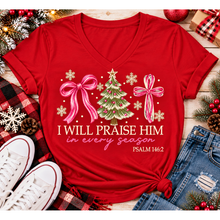 Load image into Gallery viewer, Christian Christmas shirt featuring I Will Praise Him in Every Season Psalm 146:2 graphic with pink bows, decorated Christmas tree, and cream snowflakes.
