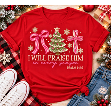 Load image into Gallery viewer, Christian Christmas shirt featuring I Will Praise Him in Every Season Psalm 146:2 graphic with pink bows, decorated Christmas tree, and cream snowflakes.
