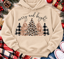 Load image into Gallery viewer, Merry and Bright Christmas graphic apparel featuring leopard print, buffalo plaid and glitter-inspired gold Christmas trees, available in three colors and four styles including crewneck tee, V-neck tee, sweatshirt and hoodie.
