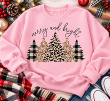 Load image into Gallery viewer, Merry and Bright Christmas graphic apparel featuring leopard print, buffalo plaid and glitter-inspired gold Christmas trees, available in three colors and four styles including crewneck tee, V-neck tee, sweatshirt and hoodie.
