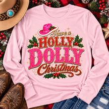 Load image into Gallery viewer, Have a Holly Dolly Christmas western graphic shirt featuring pink and red glitter-inspired lettering, a festive pink cowgirl hat, gold accents, and Christmas holly berries. Available in beige and pink in short sleeve crewneck, V-neck, long sleeve crewneck, and hoodie styles.
