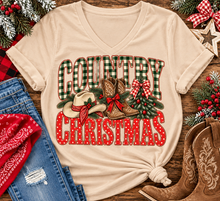 Load image into Gallery viewer, Country Christmas graphic tee with green plaid lettering, red polka dots, cowboy boots, western hat and festive Christmas bows.
