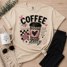 Load image into Gallery viewer, Cream Coffee My Love Language graphic tee featuring a pink and leopard print coffee cup, black checkerboard pattern, hearts, stars and Strong Coffee Positive Mind Good Vibes text.
