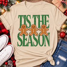 Load image into Gallery viewer, Tis the Season Christmas graphic apparel featuring green polka dot lettering and three gingerbread cookies
