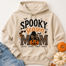 Load image into Gallery viewer, Cream Spooky Season Mom hoodie featuring leopard print lettering, coffee ghost, jack-o'-lantern pumpkin, bats and Coffee Chaos Candy Repeat text.
