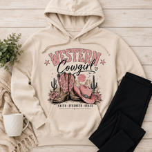 Load image into Gallery viewer, Cream Western Cowgirl hoodie featuring pink cowboy boots, pink cowgirl hat, roses, cacti, desert sunset and Faith Strength Grace graphic.
