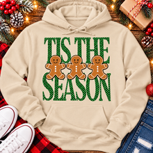 Load image into Gallery viewer, Tis the Season Christmas graphic apparel featuring green polka dot lettering and three gingerbread cookies
