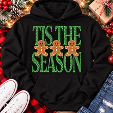 Load image into Gallery viewer, Tis the Season Christmas graphic apparel featuring green polka dot lettering and three gingerbread cookies
